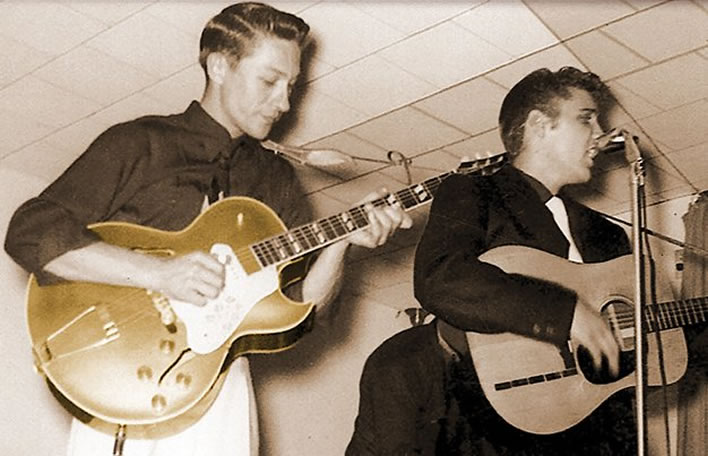 Scotty Moore and Elvis Presley on stage.